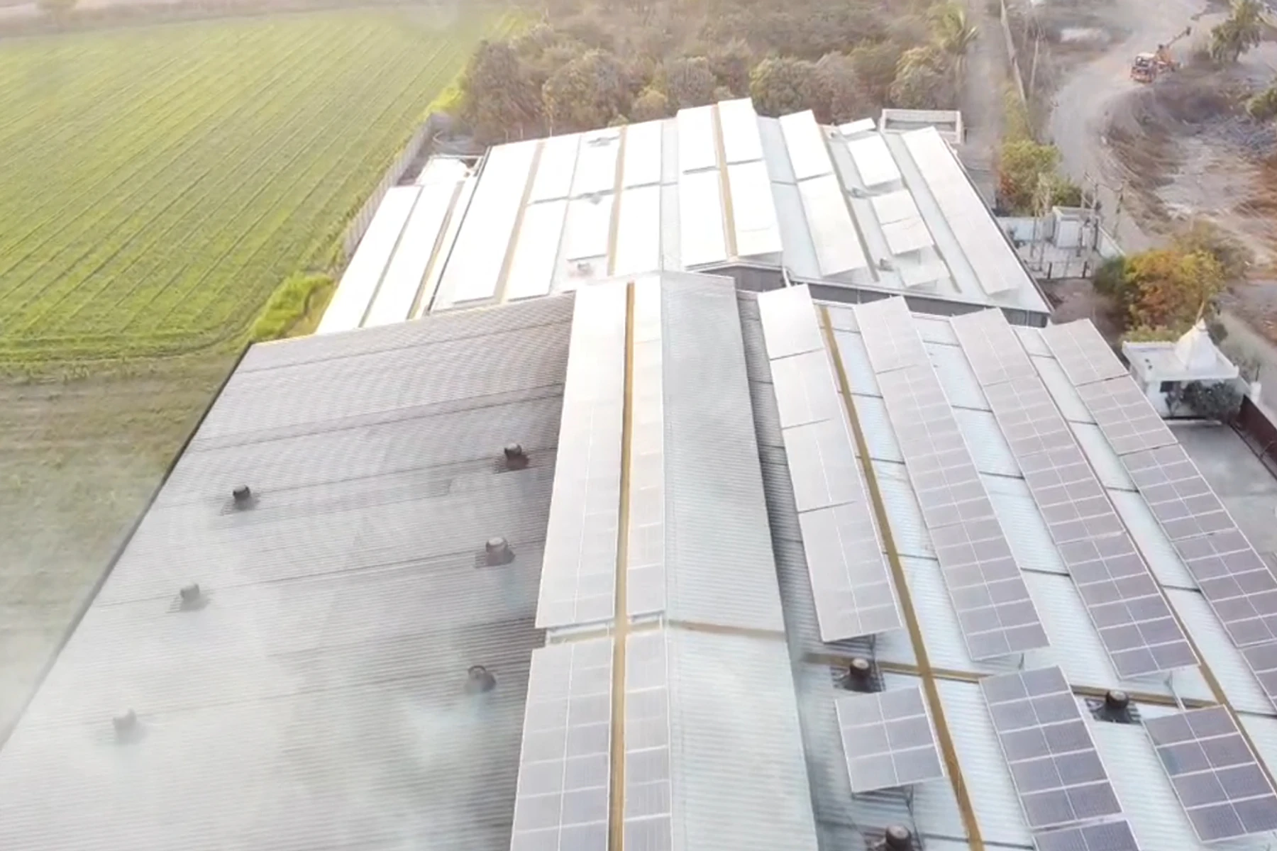 Solar panels across the roofs of large industrial sheds