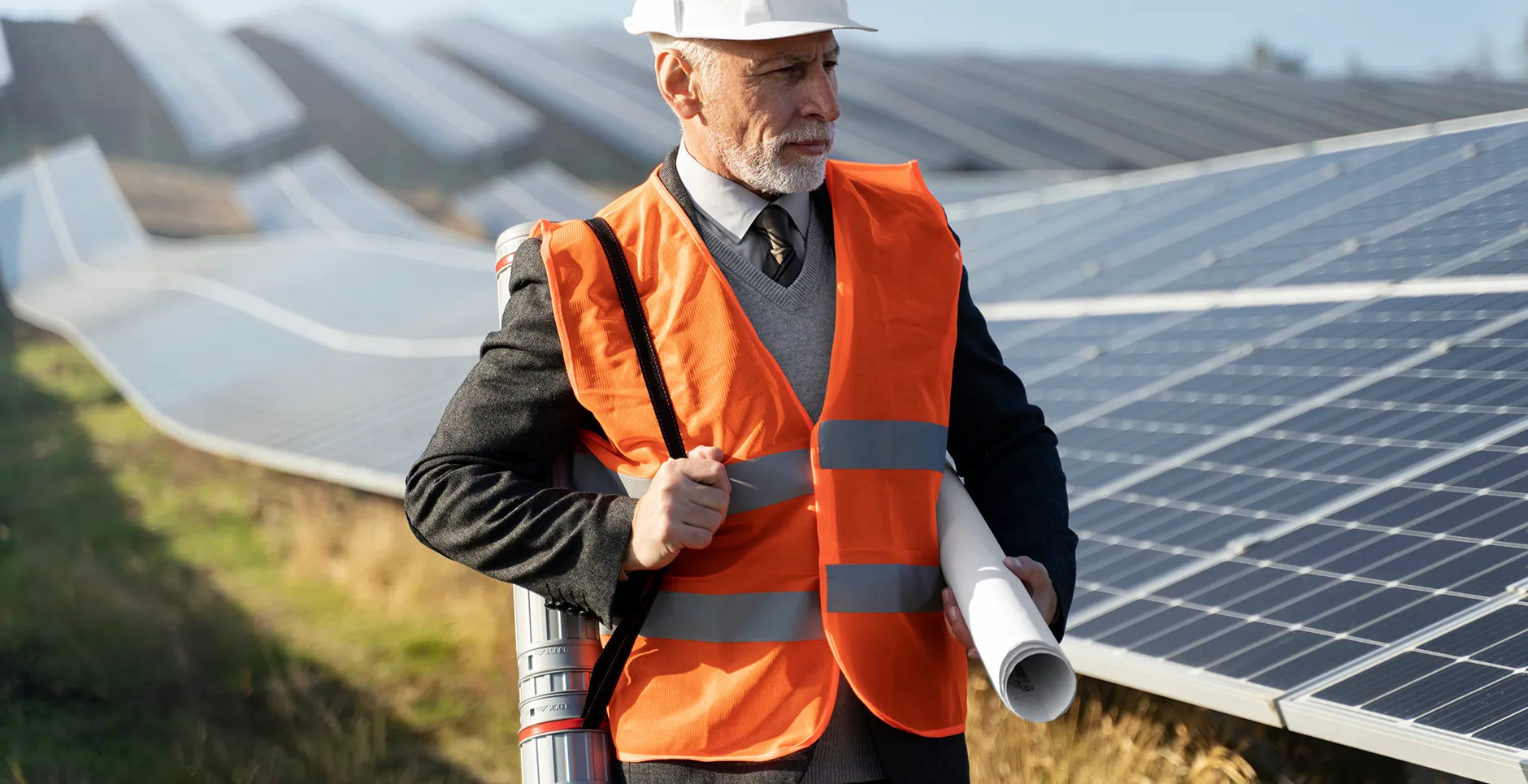 A solar consultant reviewing project plans on site